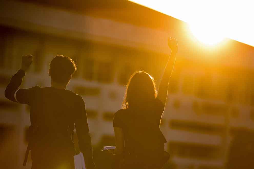 Two summer school students celebrating at sunset