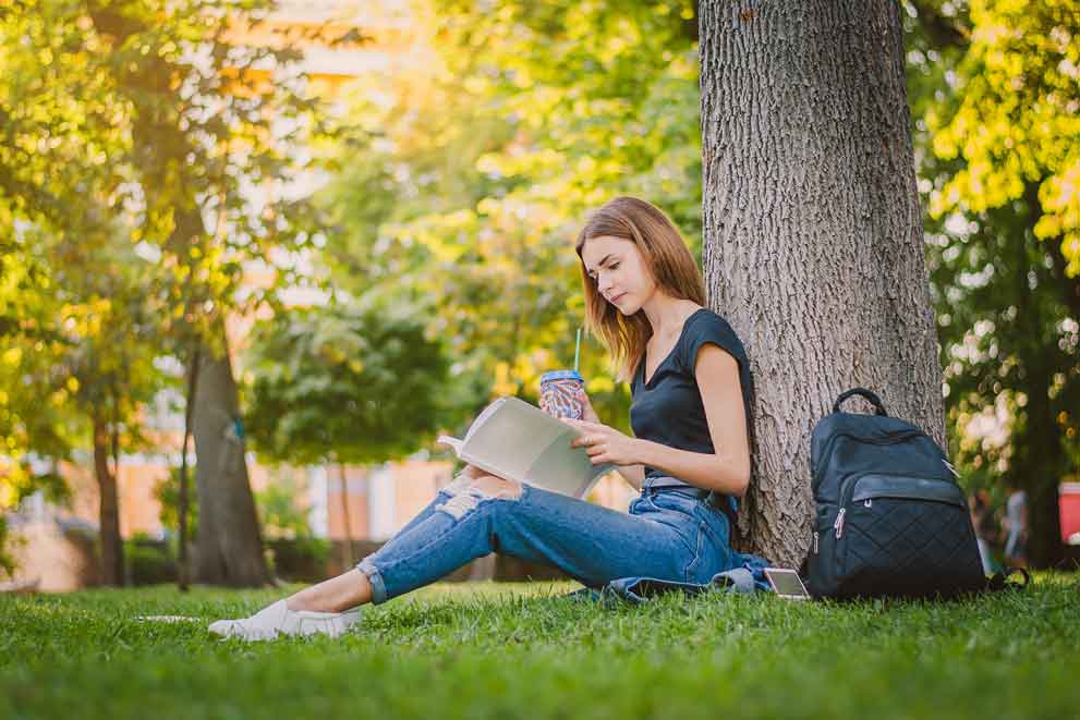 A student reading outside in Cambridge